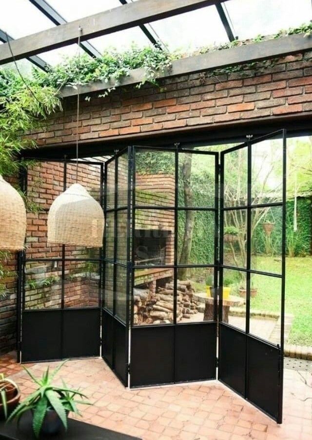 Cerramiento de galería con paneles de aluminio negro y amplios ventanales